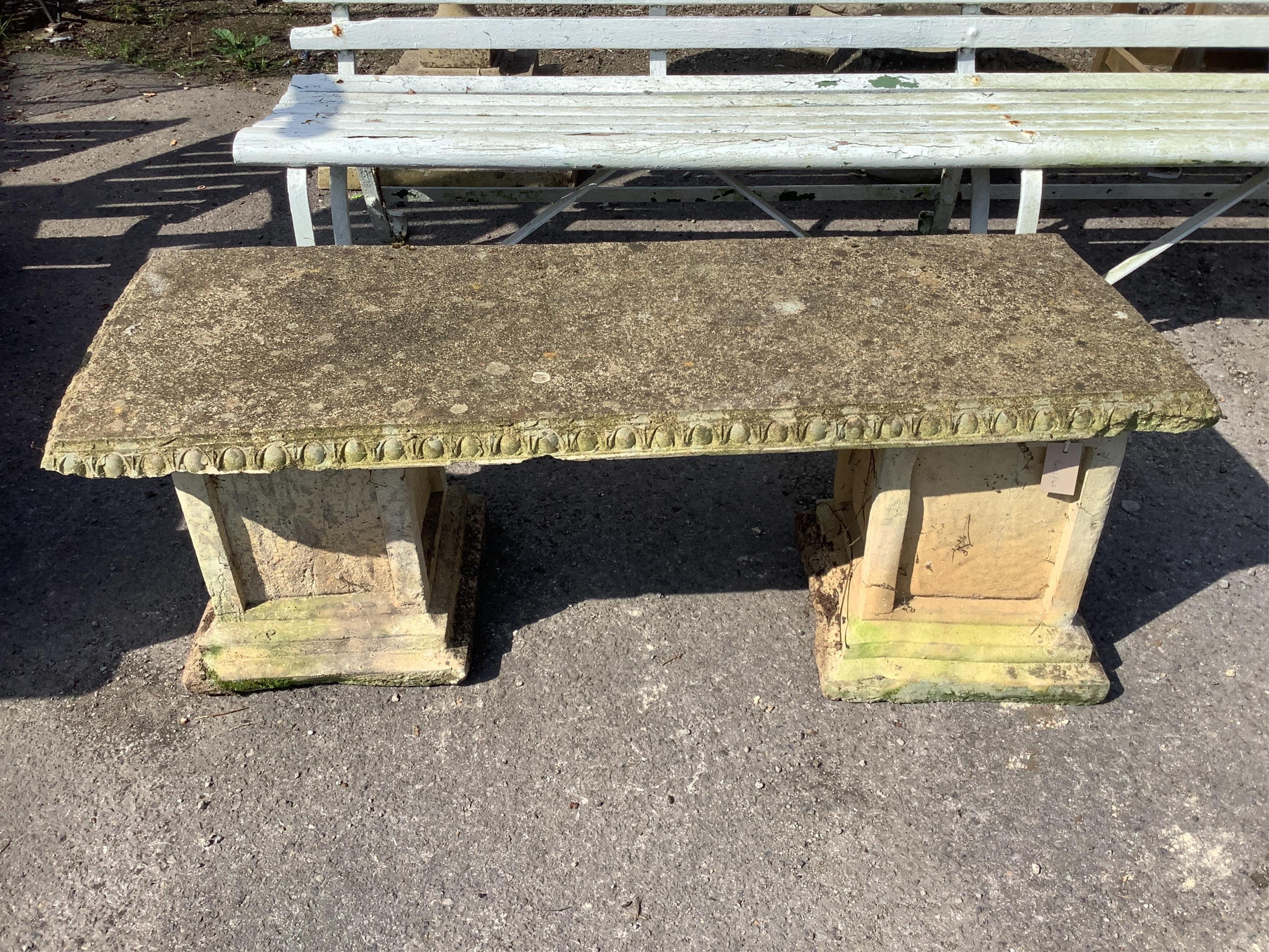 A reconstituted stone garden seat, width 118cm, depth 44cm, height 44cm